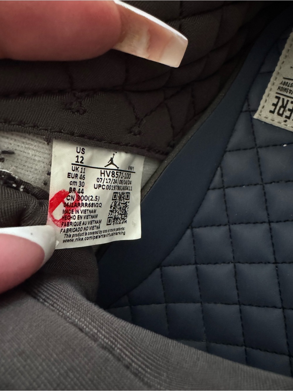 Jordan Men’s Quilted Puffer Jacket in Dark Gray and Navy.